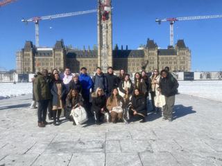A group outside Parliament in winter.