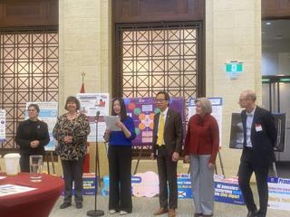 Participants standing beside project displays.