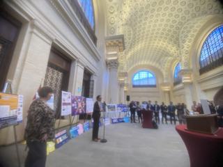 Project posters and participants throughout the event hall.