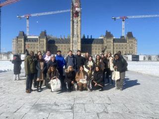 A community group outside Parliament in winter.